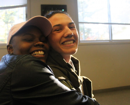 Two Teens Members of Substance Free Youth Hugging and Smiling For The Camera